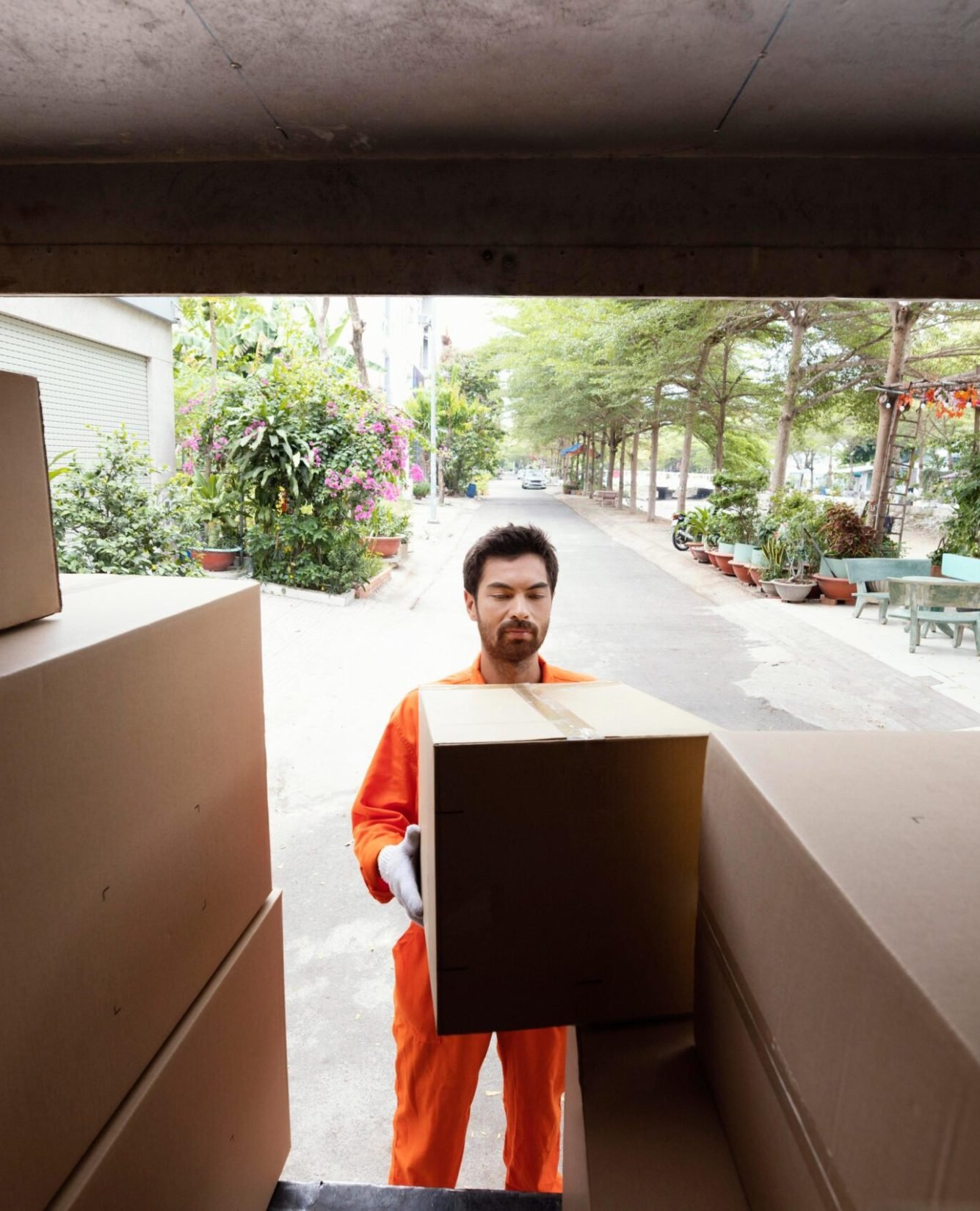 delivery-man-loading-car-with-parcel-boxes delivery-man-loading-car-with-parcel-boxes